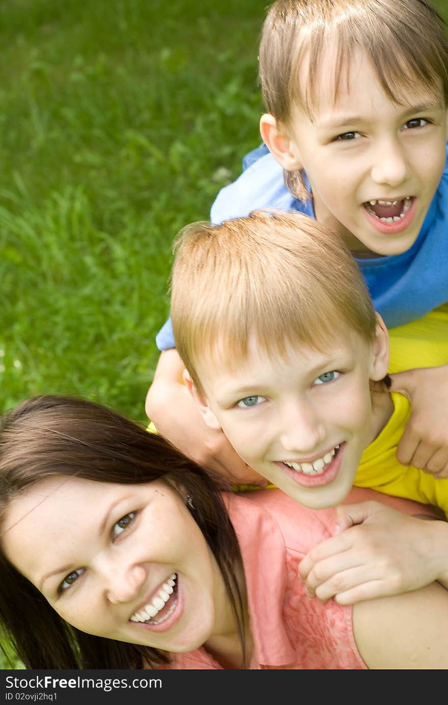 Happy boys with mom in the summer park