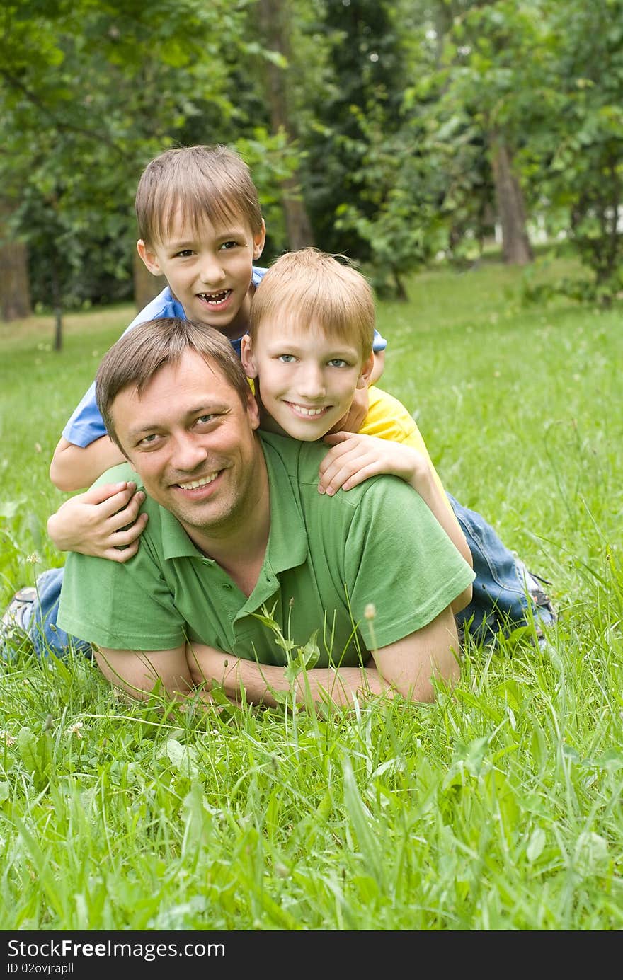 Father plays with young children outdoors. Father plays with young children outdoors