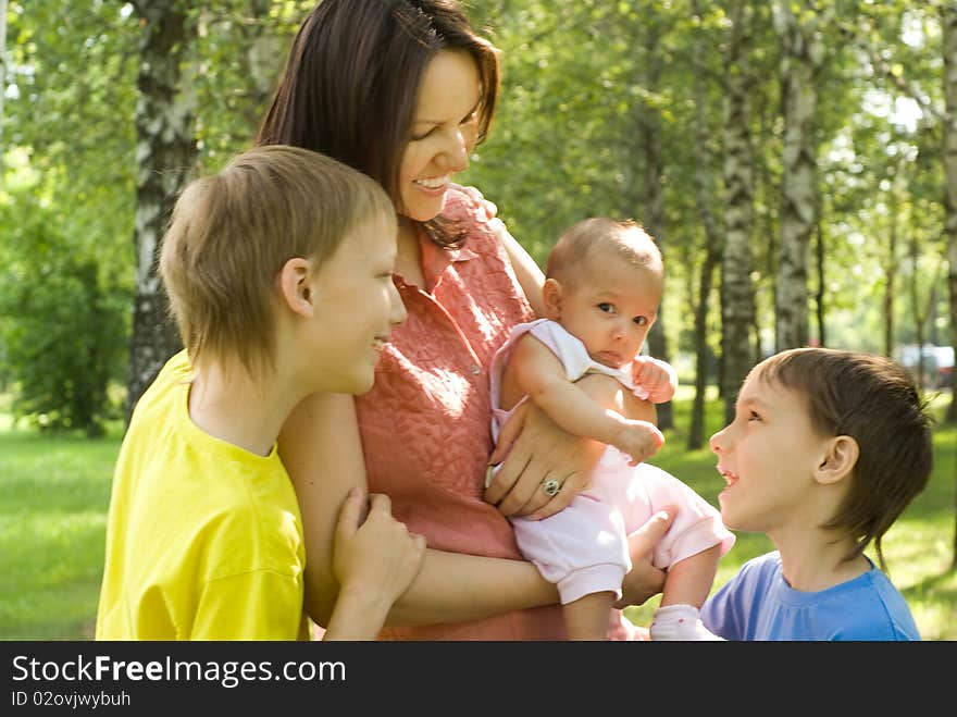 Happy boys with mom  in the summer park