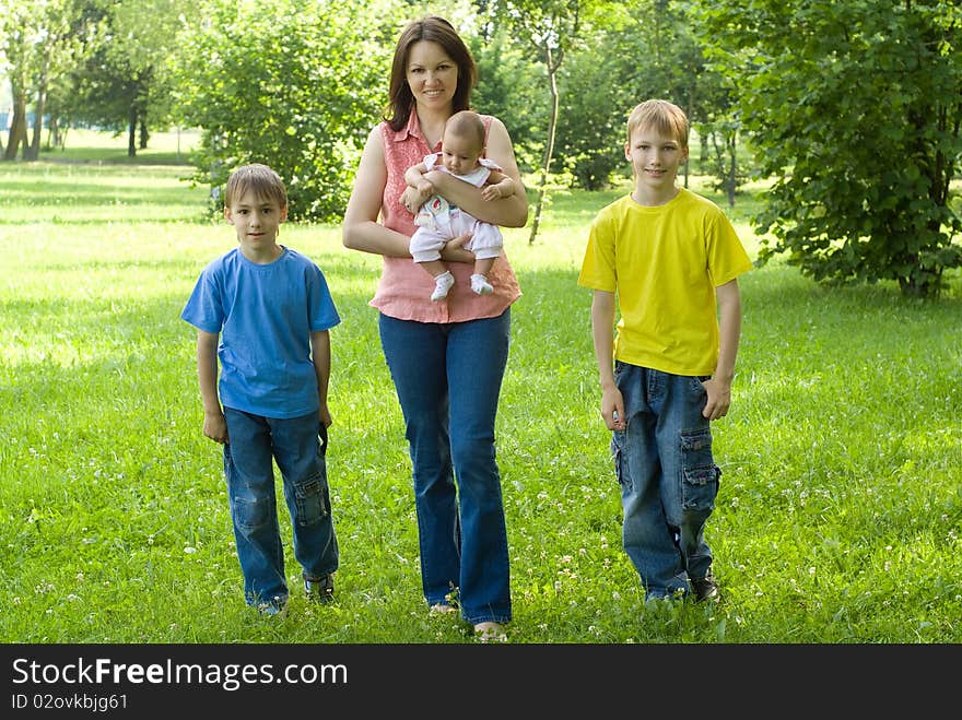 Portrait of a happy family of four on the nature