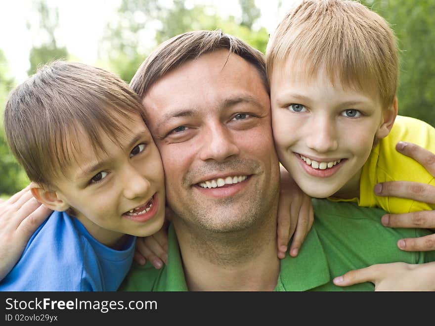 Dad plays with young children outdoors