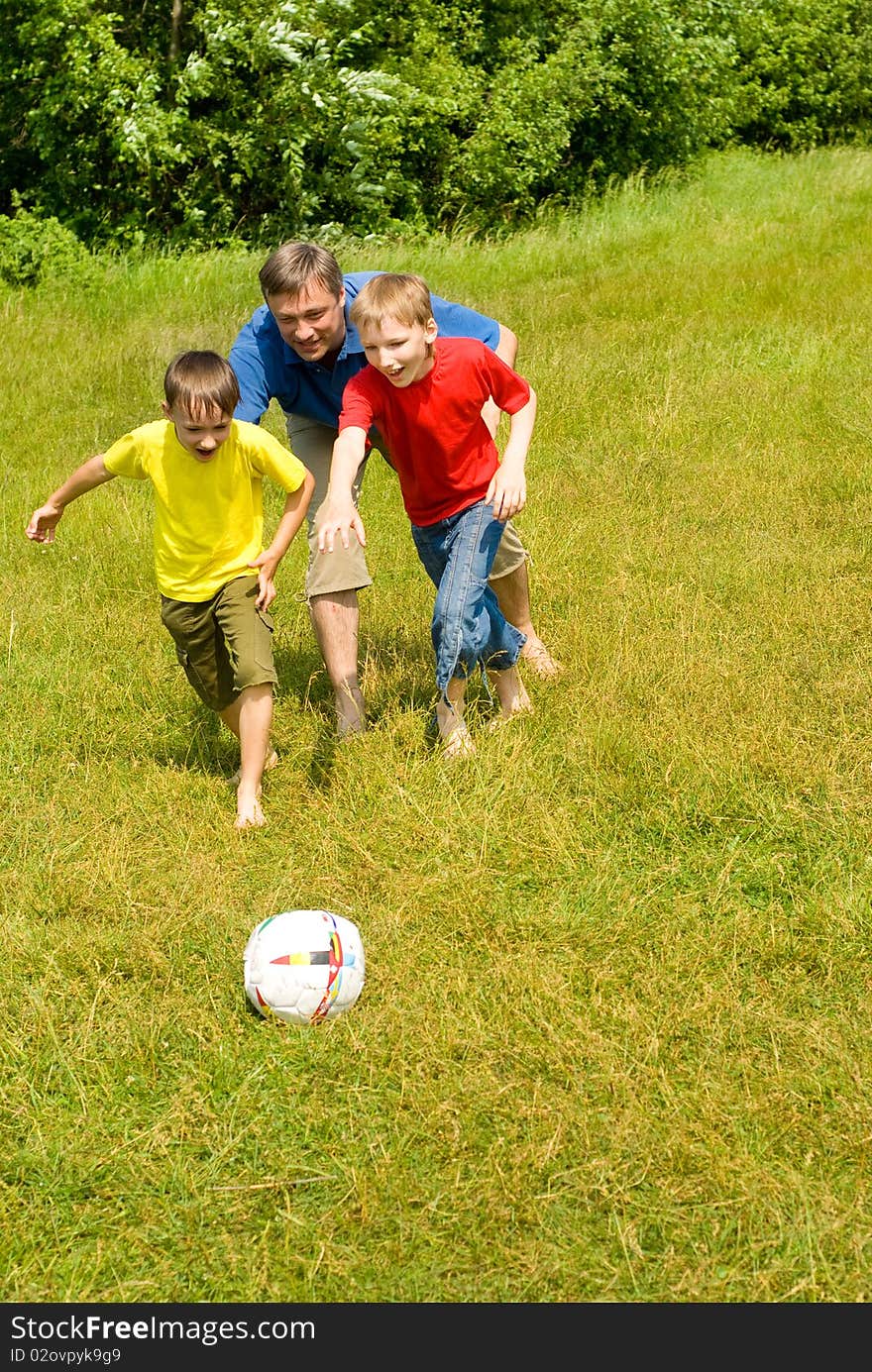 Dad playing with his children in football