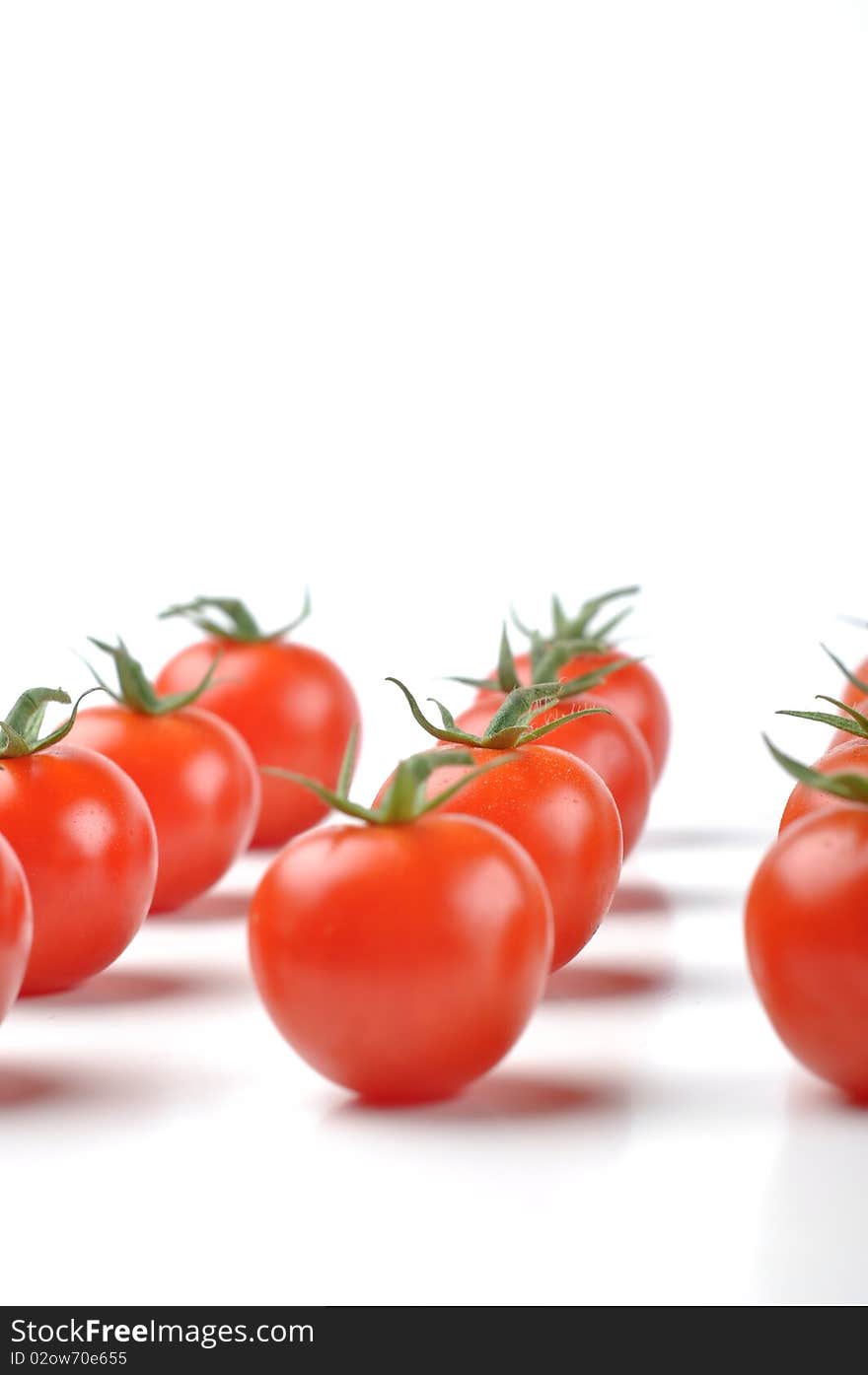 Little red cherry tomatoes isolated on white background. Little red cherry tomatoes isolated on white background