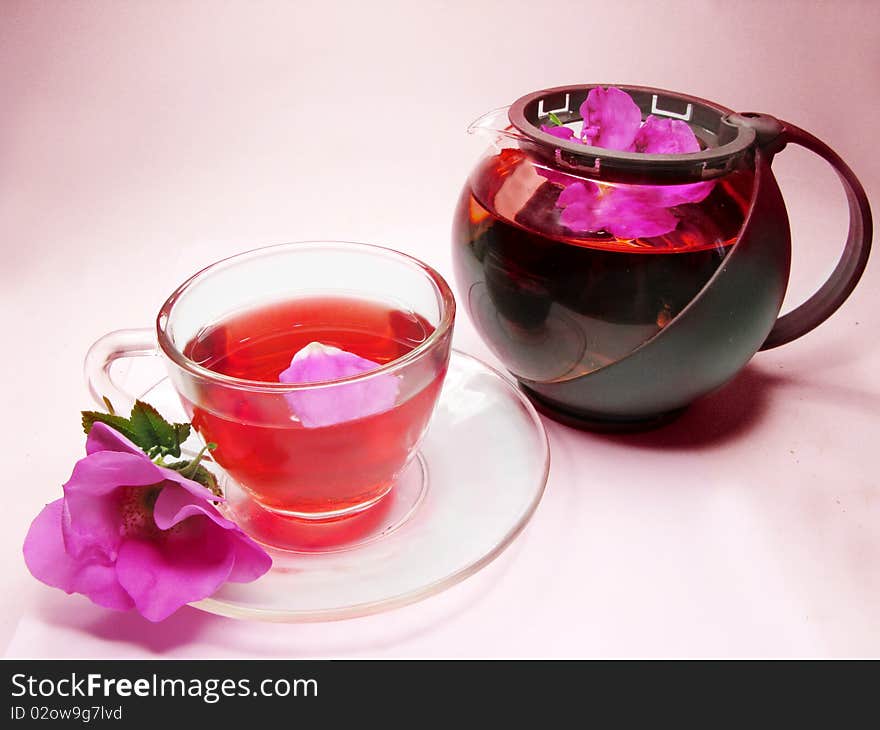 Herbal floral tea with wild rose on pink background