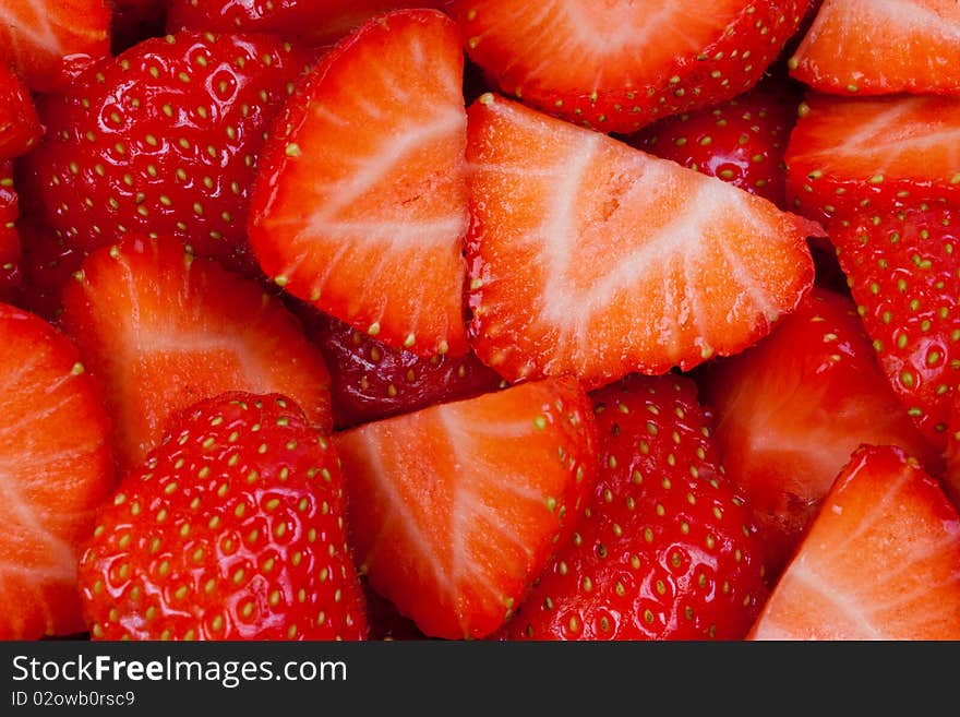 Close up of strawberries with some cut into slices. Close up of strawberries with some cut into slices