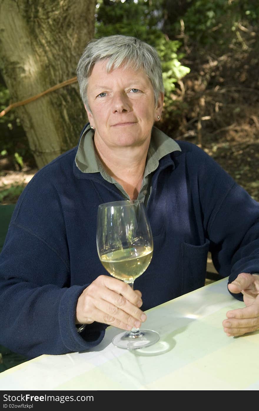 Senior women with wine glass in garden