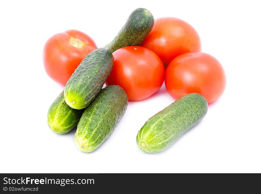 Cucumbers and tomatoes isolated on white background