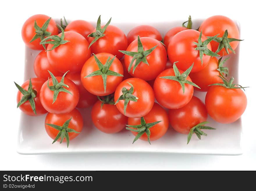 Freshly picked cherry tomatoes isolated on white background