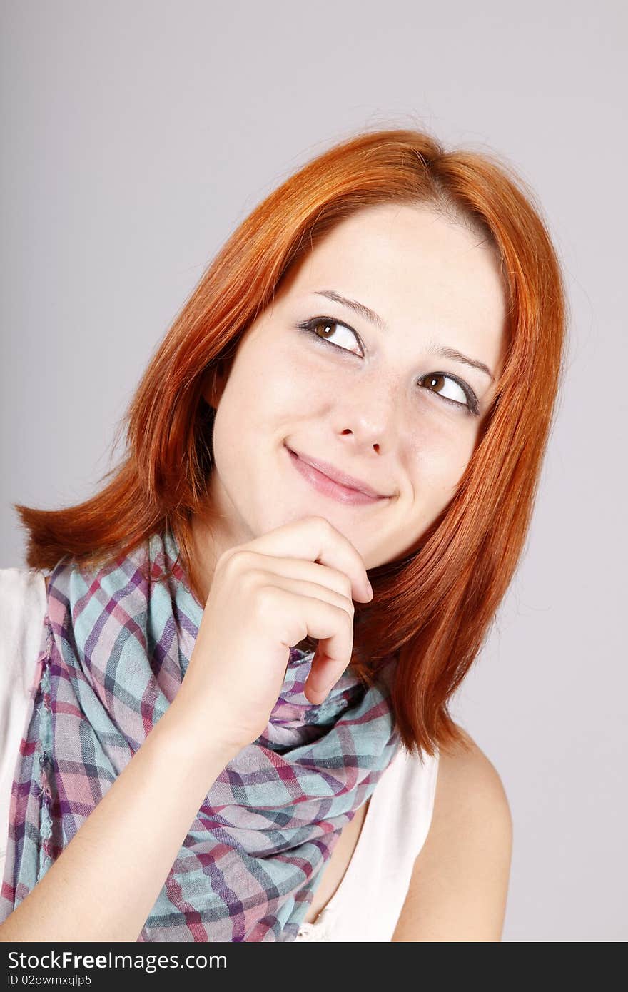 Portrait of beautiful red-haired girl. Studio shot.