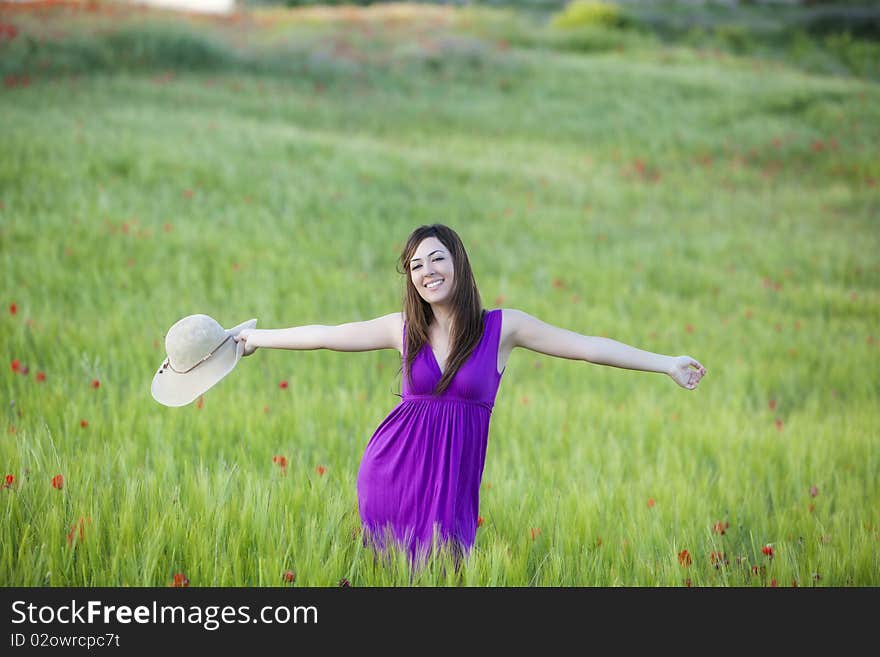 Young beautiful girl feeling freedom on meadow. Young beautiful girl feeling freedom on meadow