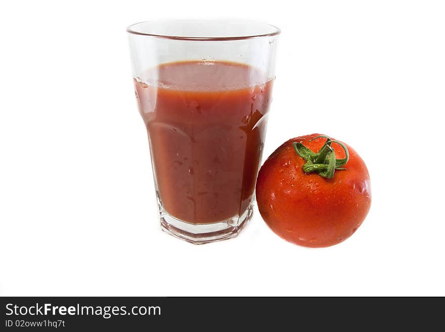 Big glass of tomato juice and a tomato isolated on white, for a healthy food. Big glass of tomato juice and a tomato isolated on white, for a healthy food