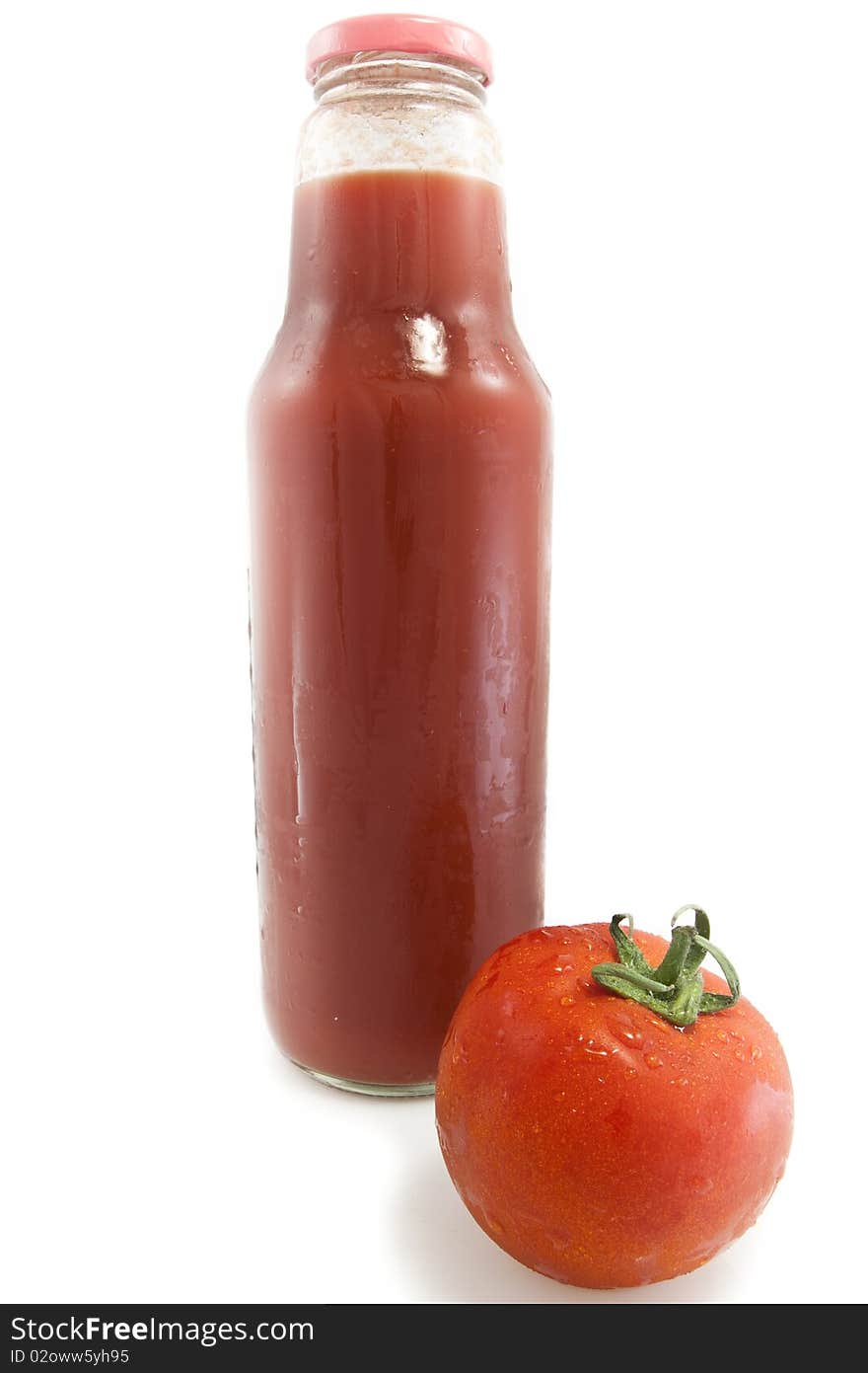 Big bottle of tomato juice and a red tomato isolated on white background. Big bottle of tomato juice and a red tomato isolated on white background