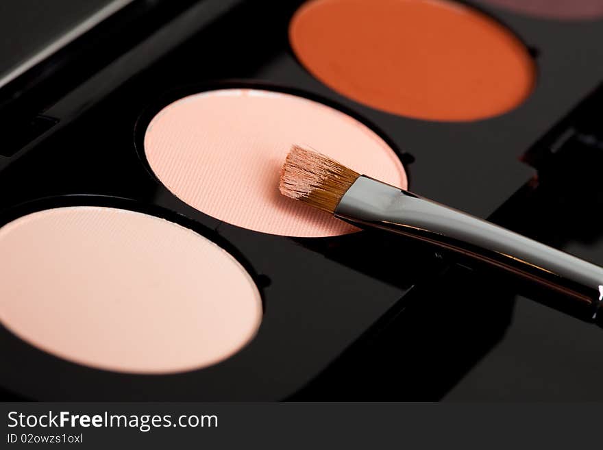 Make-up eyeshadows and cosmetic brush