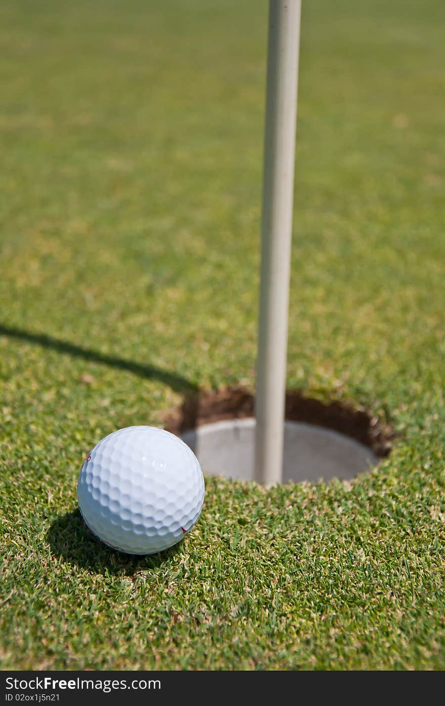 Golf hole with ball and flag