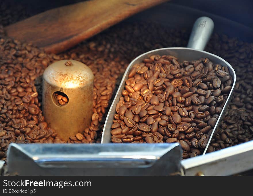 Freshly roasted coffee beans in a cup. Freshly roasted coffee beans in a cup.