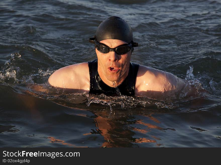 A man doing the breast stoke outdoors. A man doing the breast stoke outdoors.