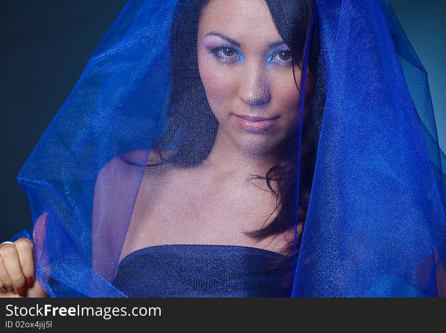 Beautiful girl with blue veil