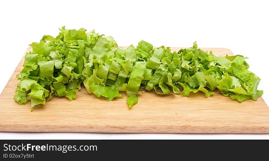 Green lettuce salad slices on wooden plate