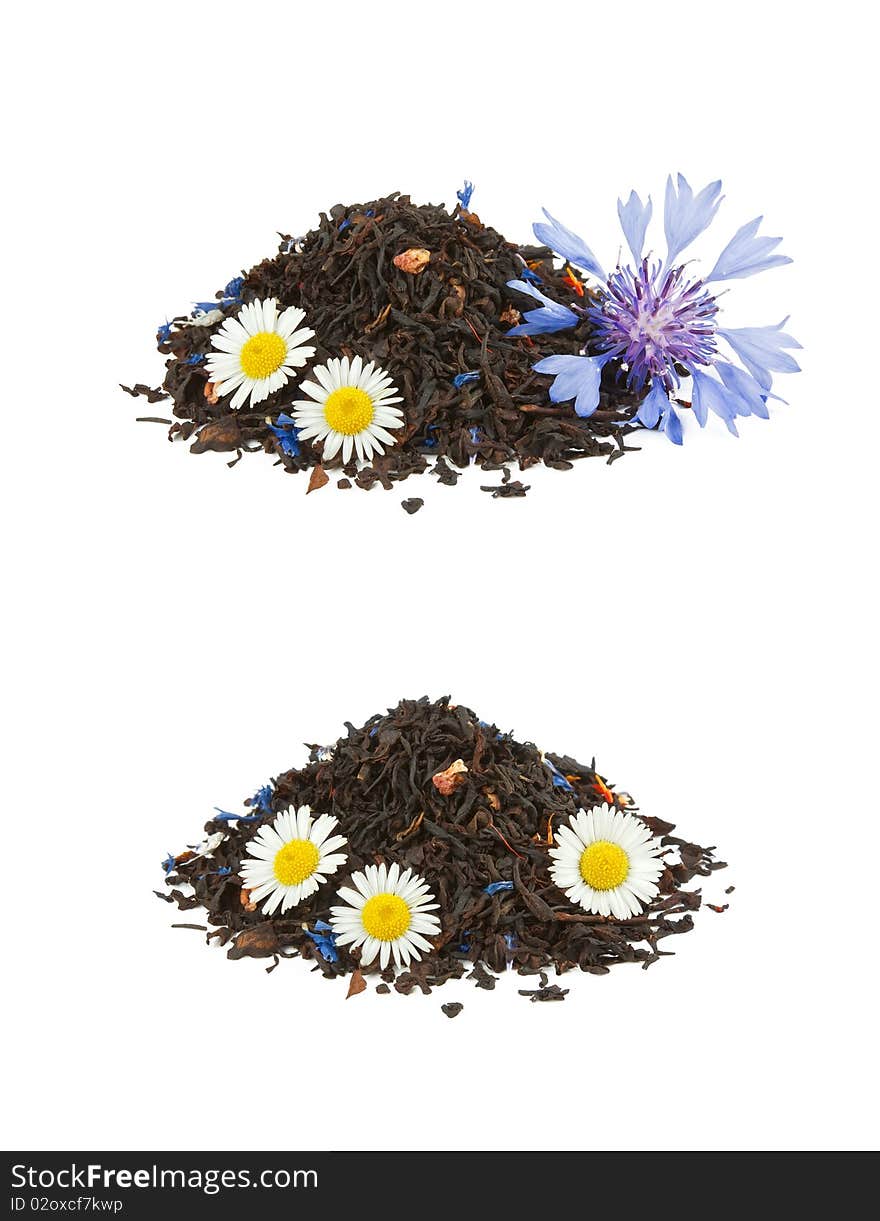 Two heaps of black mixed tea with camomiles and cornflower isolated on white. Two heaps of black mixed tea with camomiles and cornflower isolated on white