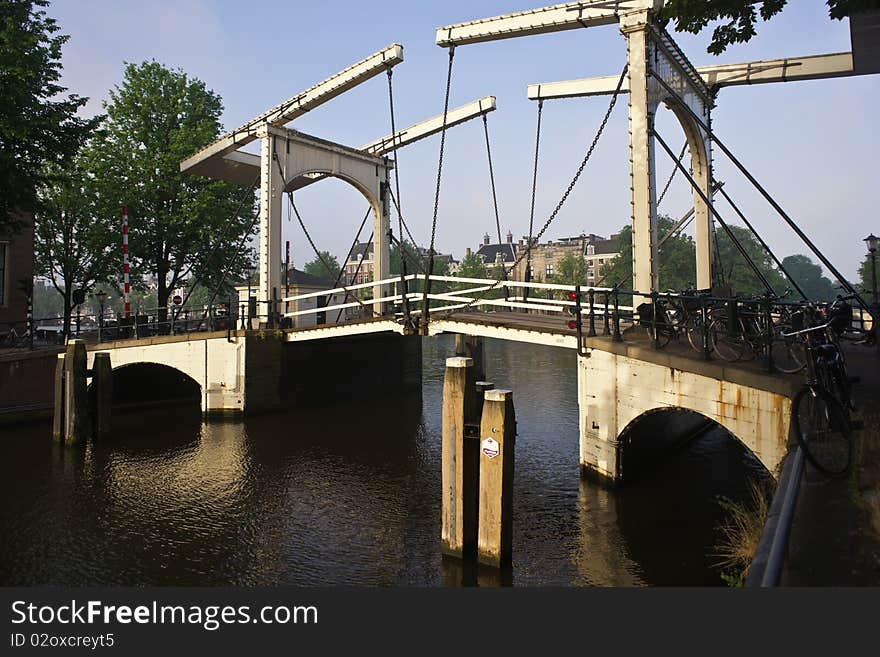 A bridge over one of the many canals in Amsterdam. A bridge over one of the many canals in Amsterdam.