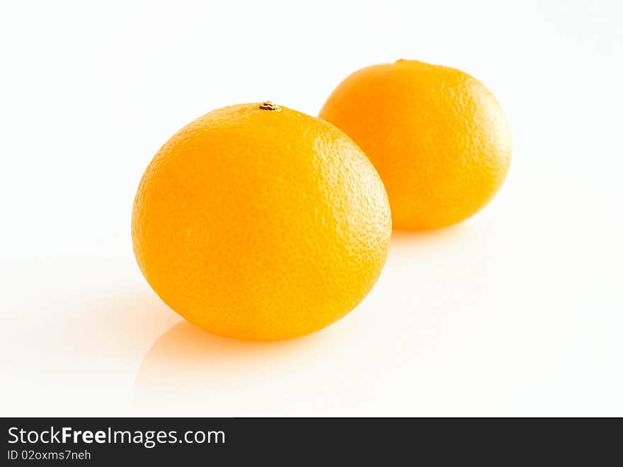 Two ripe tangerines, close-up, on white background. Two ripe tangerines, close-up, on white background.