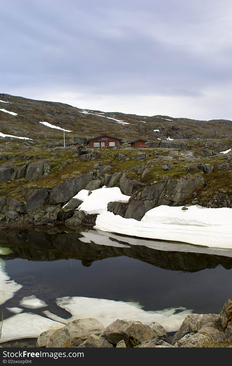 Mountain landscape with the lake and snow