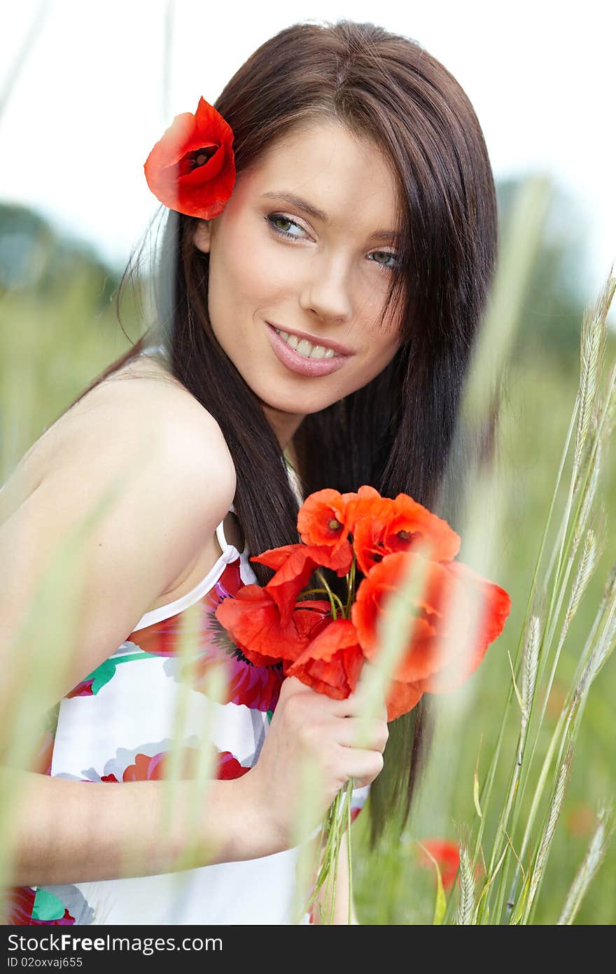 Summer girl running in poppy field