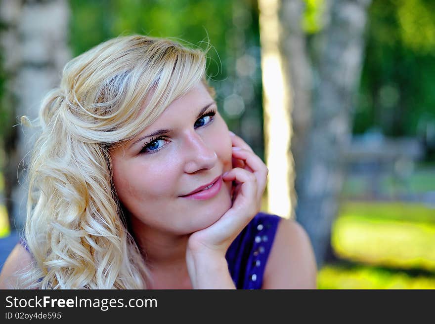 Beautiful young woman with fashion hairstyle outdoors in summer park. blurred background. Beautiful young woman with fashion hairstyle outdoors in summer park. blurred background