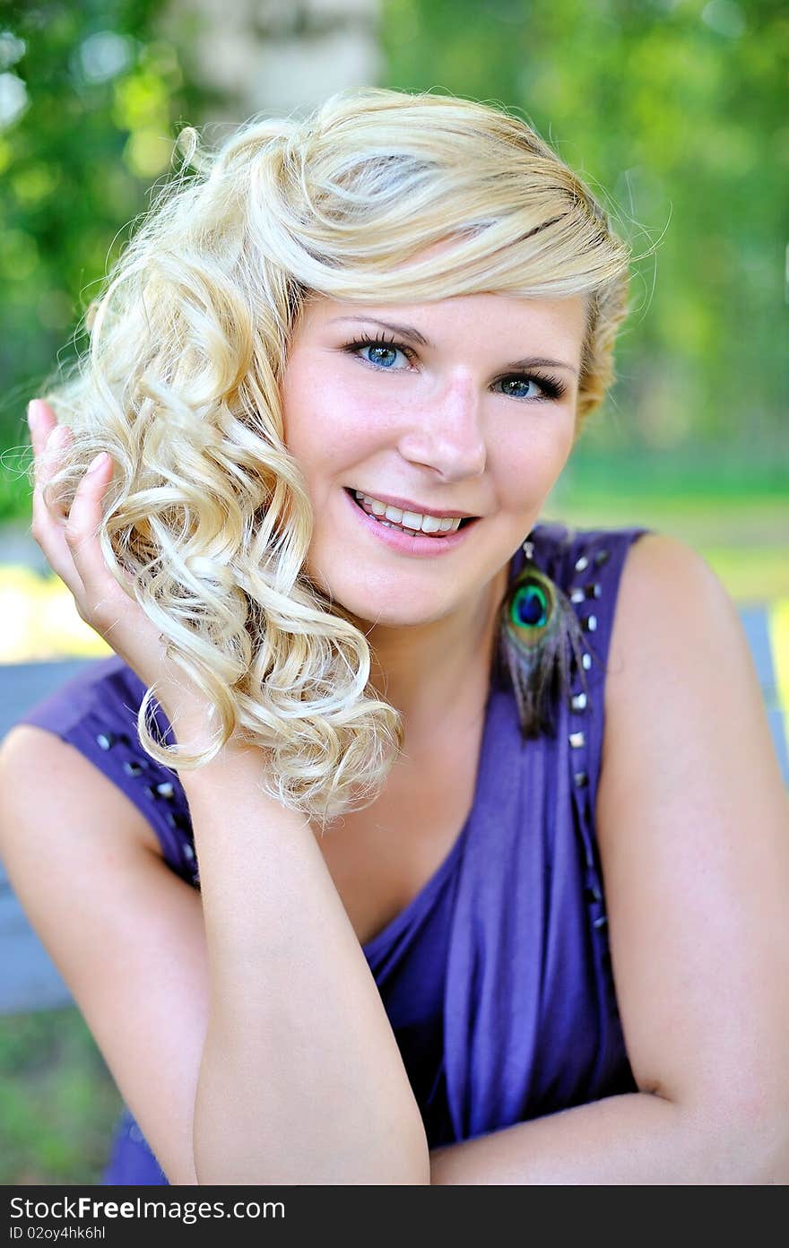 Beautiful young woman with fashion hairstyle outdoors in summer park. blurred background. Beautiful young woman with fashion hairstyle outdoors in summer park. blurred background