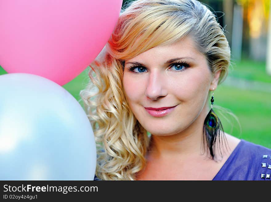 Beautiful young woman with fashion haitstyle with baloons outdoors smiling. Beautiful young woman with fashion haitstyle with baloons outdoors smiling.