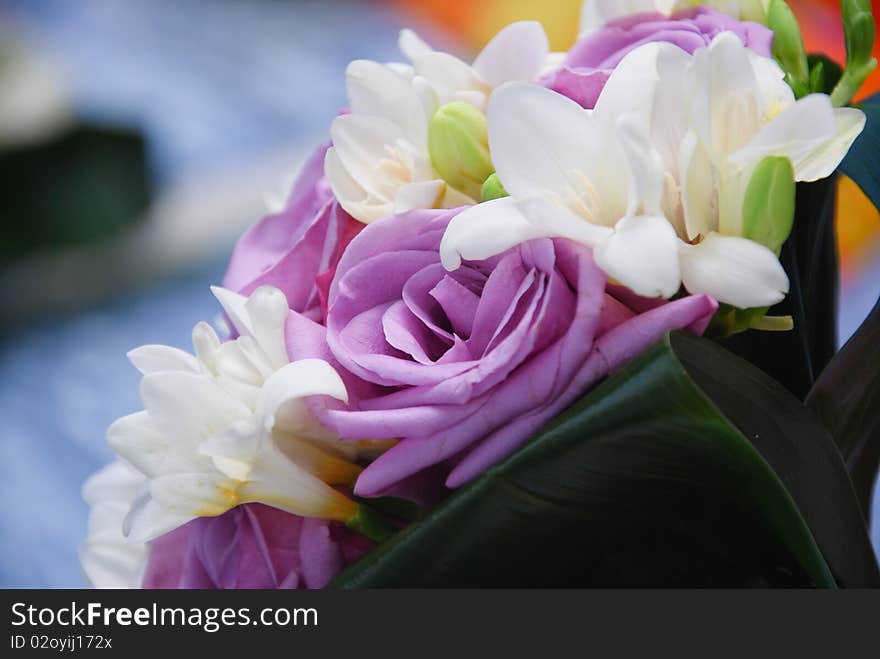 A bridal bouquet of lila and white roses.