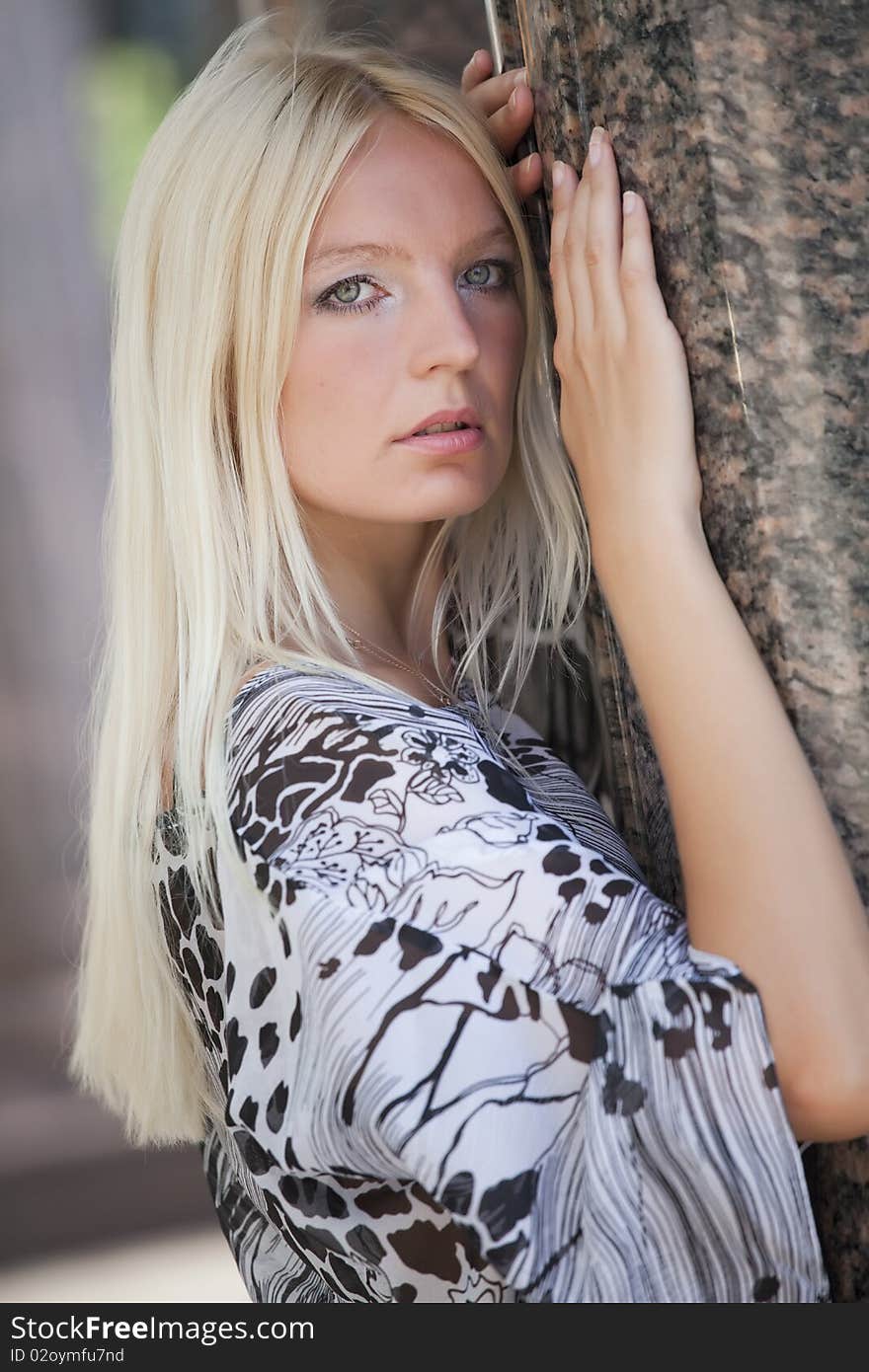 Blond fashion woman posing at the marble wall