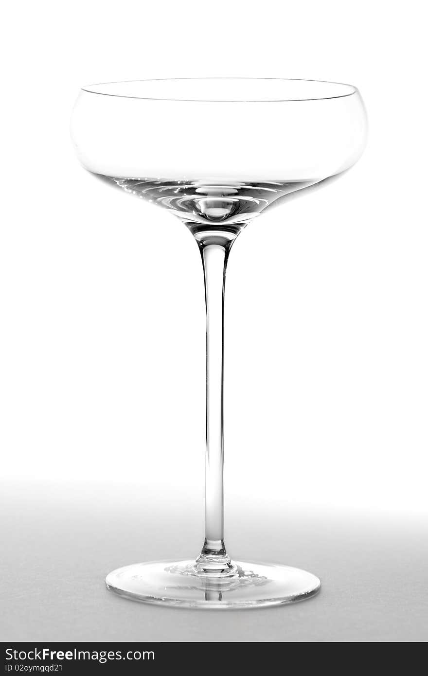 An empty saucer style champage glass.  Studio isolated on a white background. An empty saucer style champage glass.  Studio isolated on a white background.