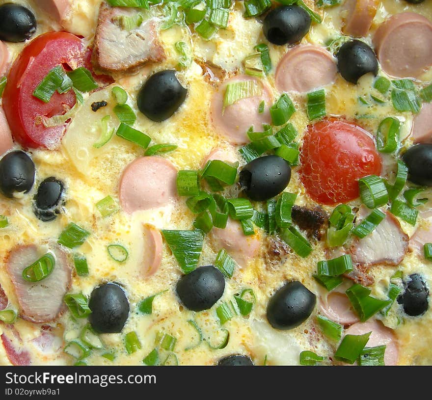 Omelet with sausages and vegetables is shown in the picture. Omelet with sausages and vegetables is shown in the picture.