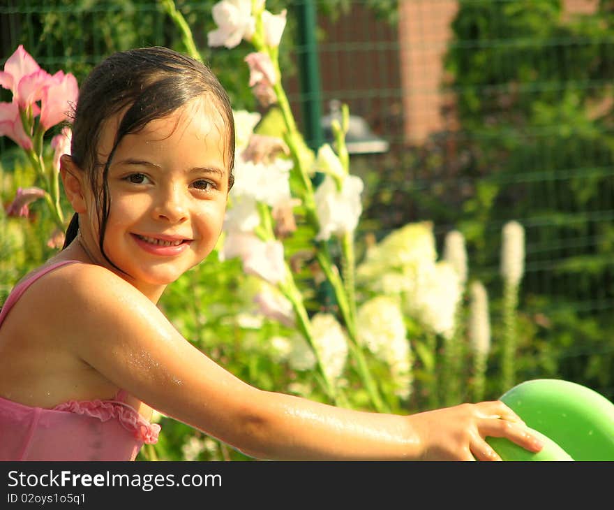 Wet and little girl are smiling