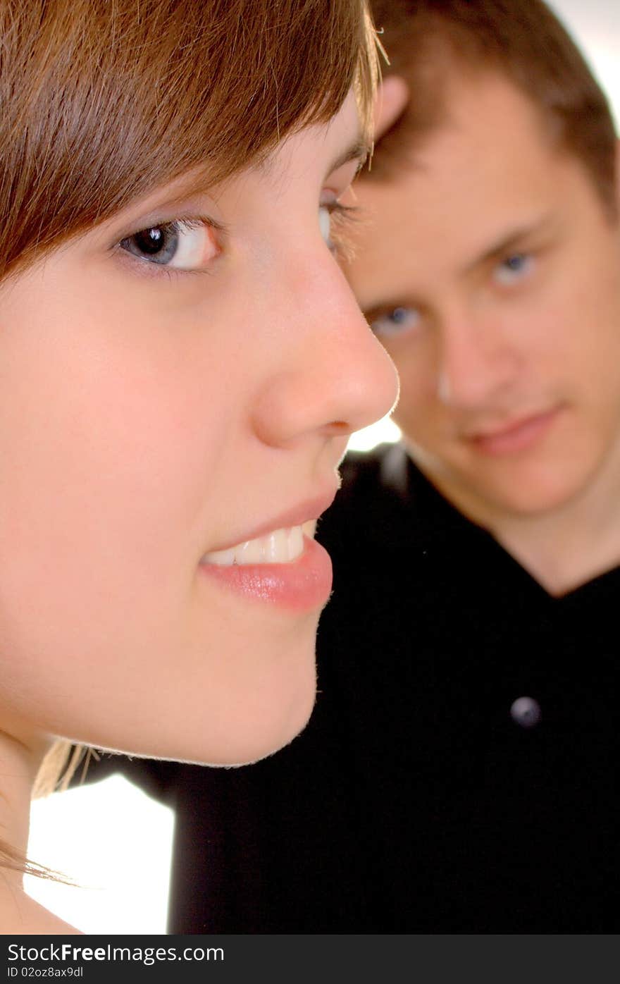 Young woman is smiling and her boyfriend is thinking. Young woman is smiling and her boyfriend is thinking