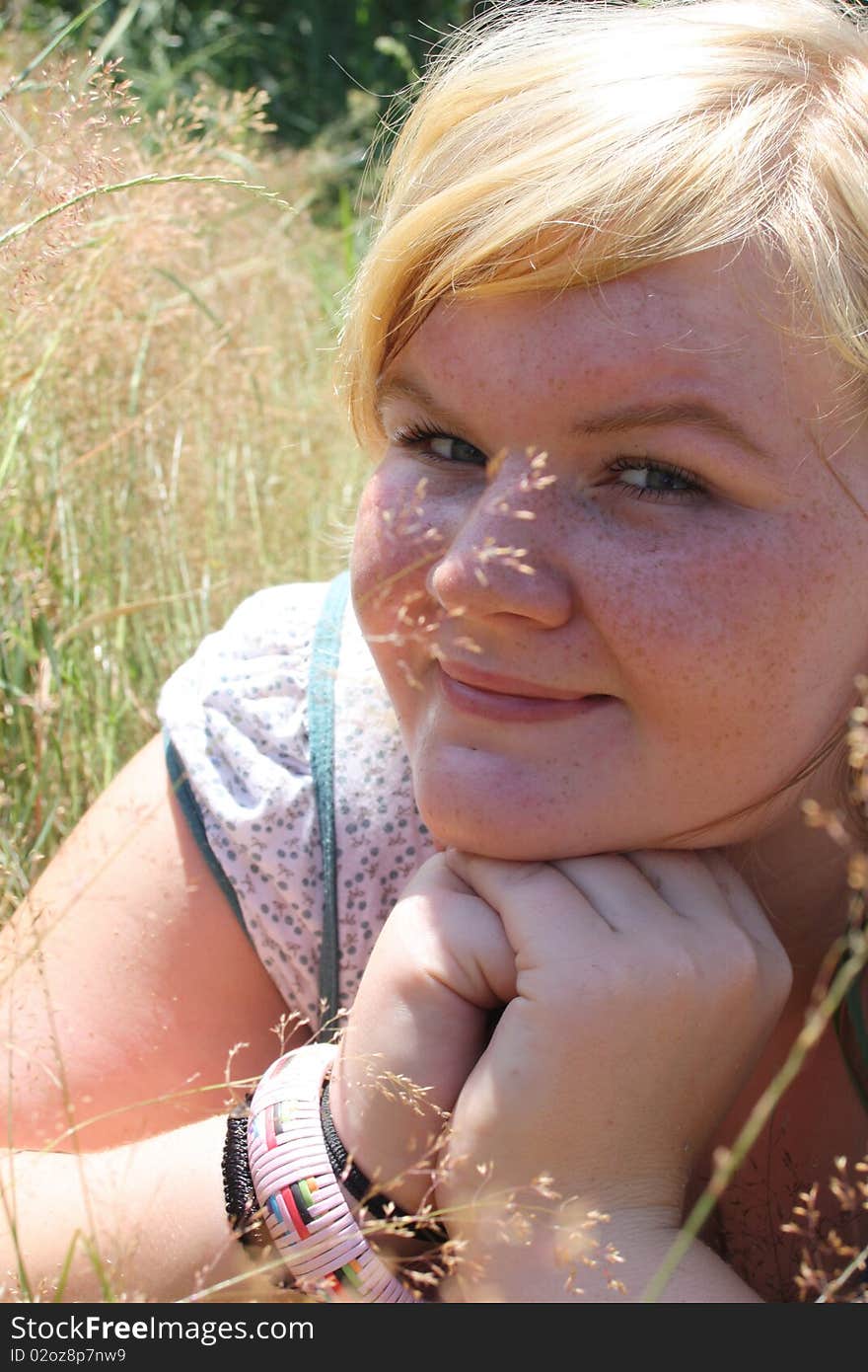 Happy woman laying on grass