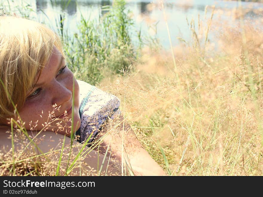 Happy woman laying on grass