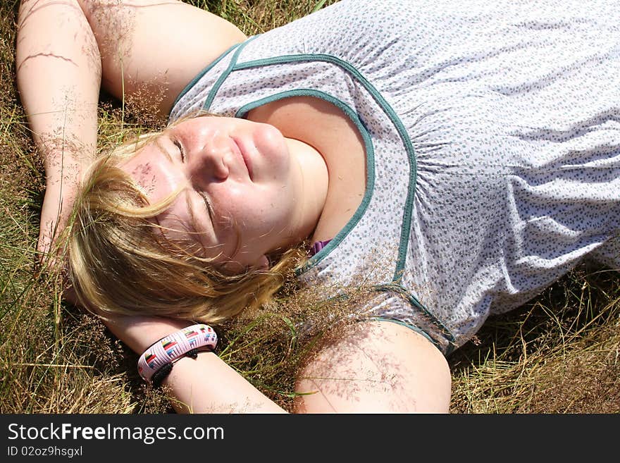 Relaxing woman laying on grass