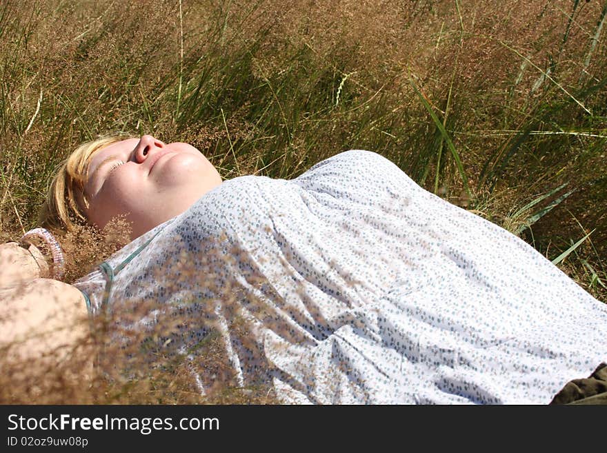 Relaxing woman laying on grass