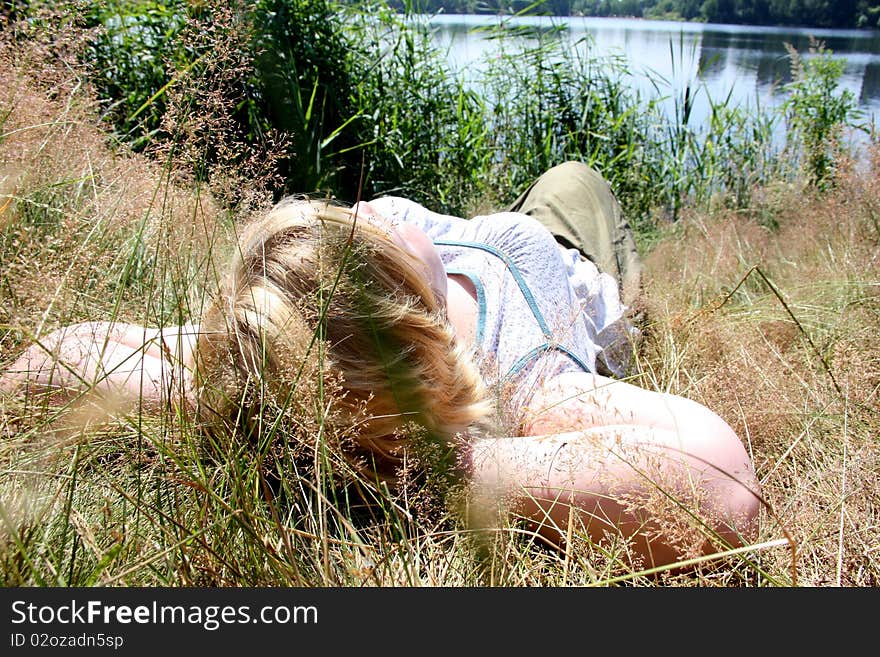 Relaxing woman laying on grass