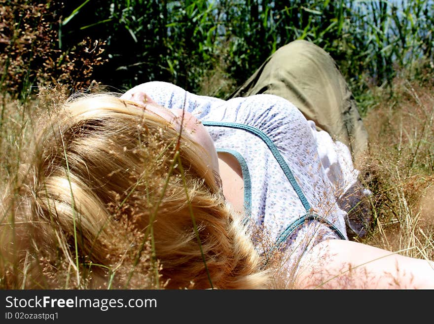 Relaxing woman laying on grass