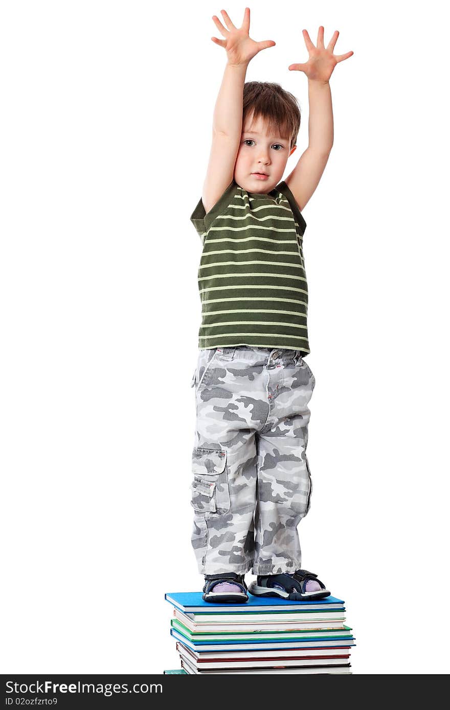 Portrait of a cute little boy standing on books. Isolated over white background. Portrait of a cute little boy standing on books. Isolated over white background.