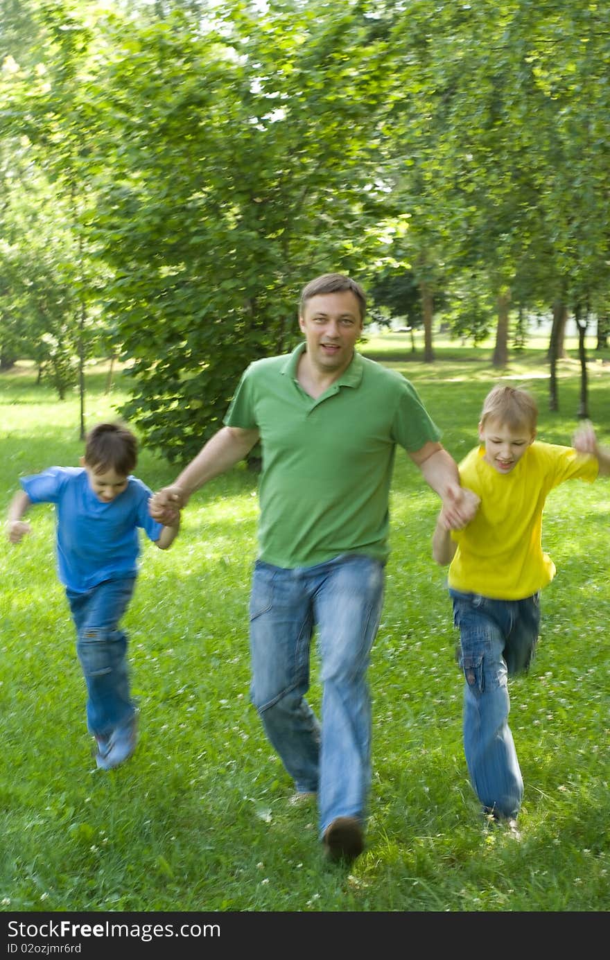 Father playing with her two children on nature. Father playing with her two children on nature