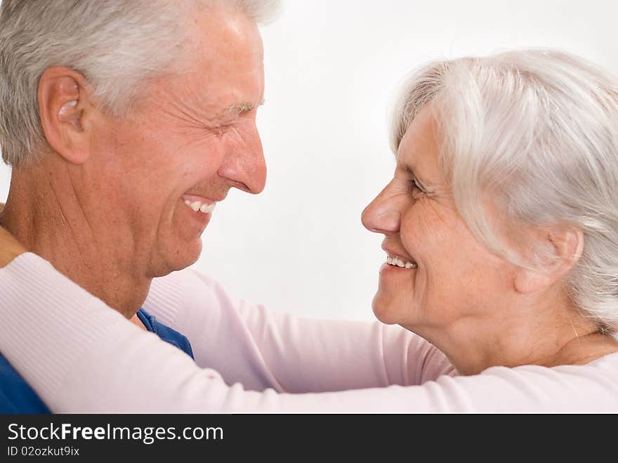 Happy elderly couple together on a white background