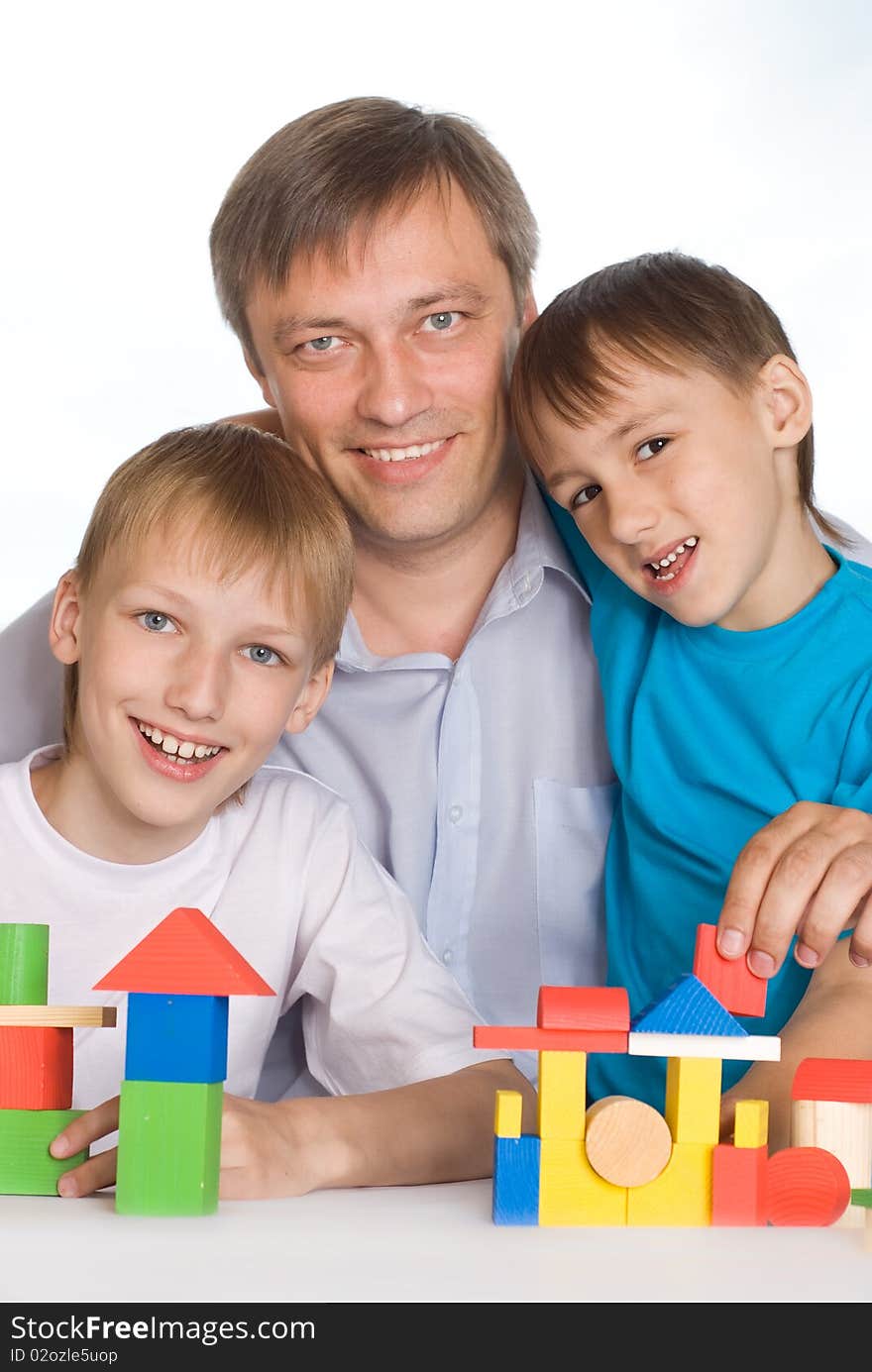 Happy father with children playing on the floor