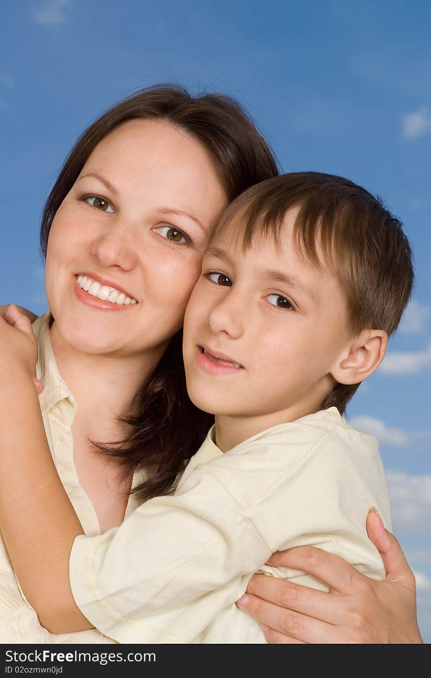 Woman woman  with  son on a background of sky. Woman woman  with  son on a background of sky