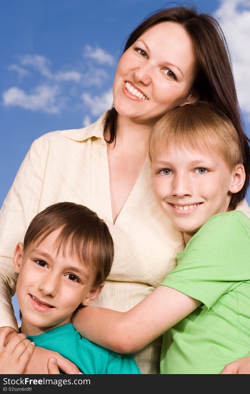 Mother with children at the background of the sky. Mother with children at the background of the sky