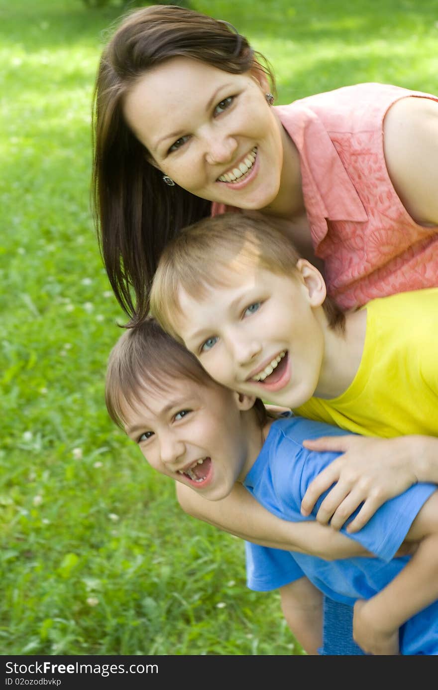 Woman woman  with  sons on a background of grass. Woman woman  with  sons on a background of grass