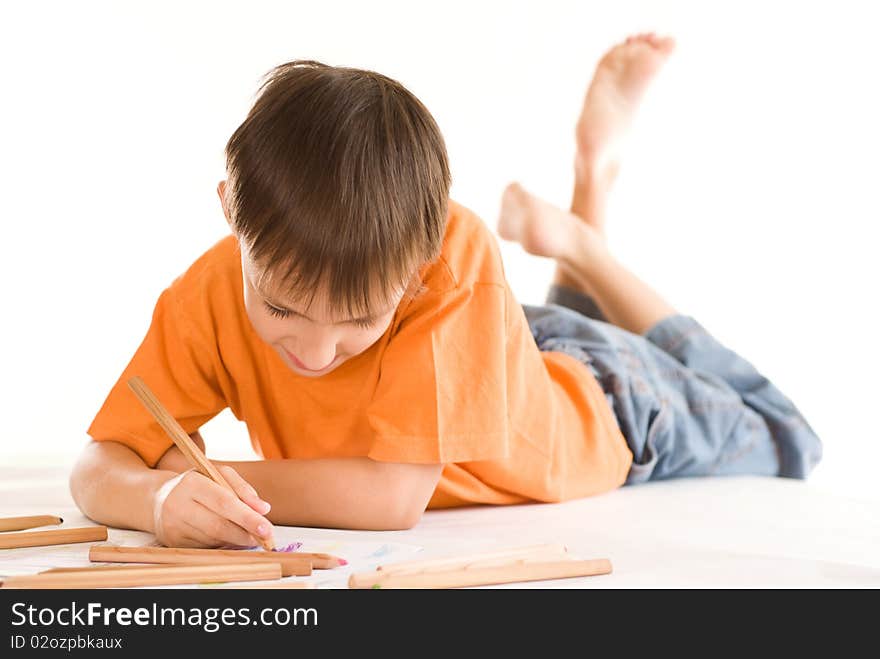 Boy lying on the floor and draw. Boy lying on the floor and draw